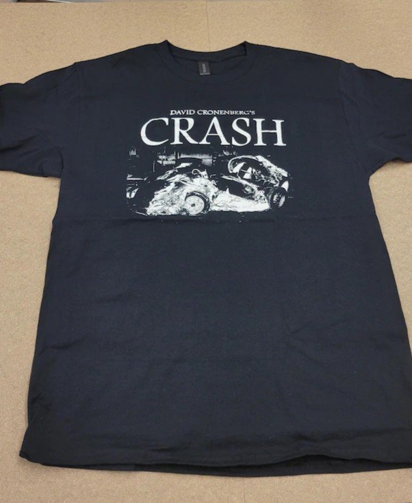 Crisis Hotline merch: navy t-shirt reading CRASH with a car crash graphic